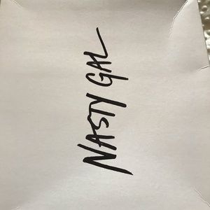 A pair of thigh high Nasty Gal boots.